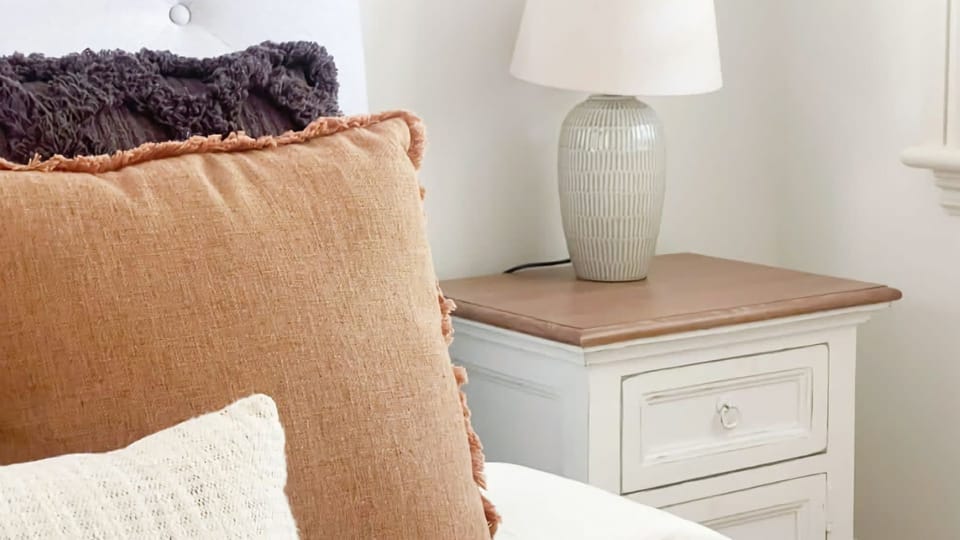 Cozy side table lamp adding warmth and charm to the bedroom.