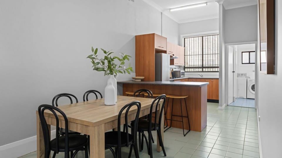 A practical space where dining, cooking, and laundry flow together effortlessly.