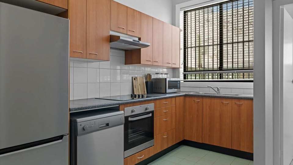 A fresh and airy kitchen space designed with natural light and warm tones.