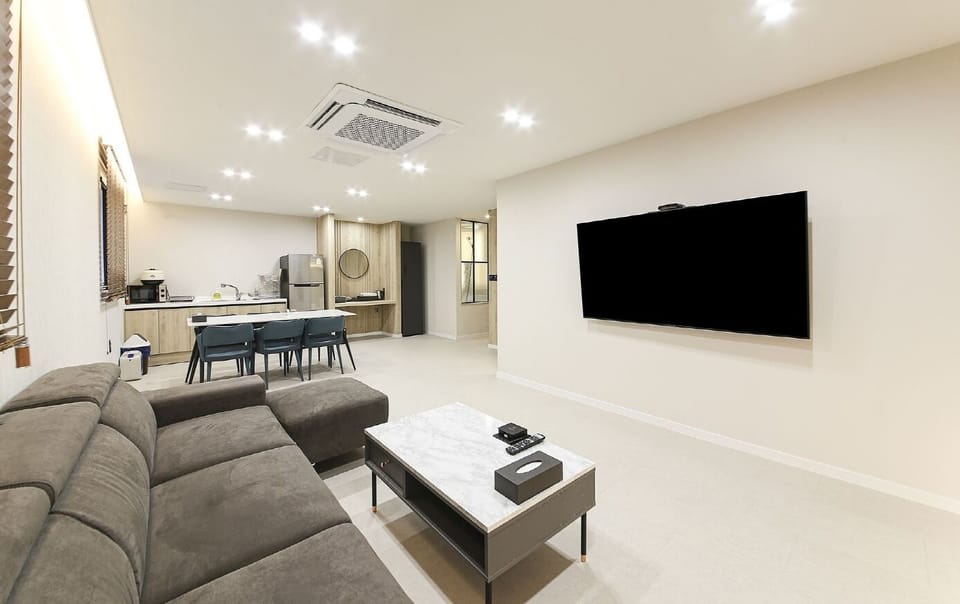 Deluxe Family | Living area | 75-inch Smart TV with cable channels, Netflix, streaming services