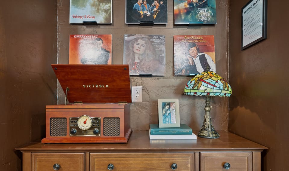 The record player is just decorative now (guests kept breaking our record player), but the bluetooth + radio function works so you can listen to radio or connect your phone to play music : )
