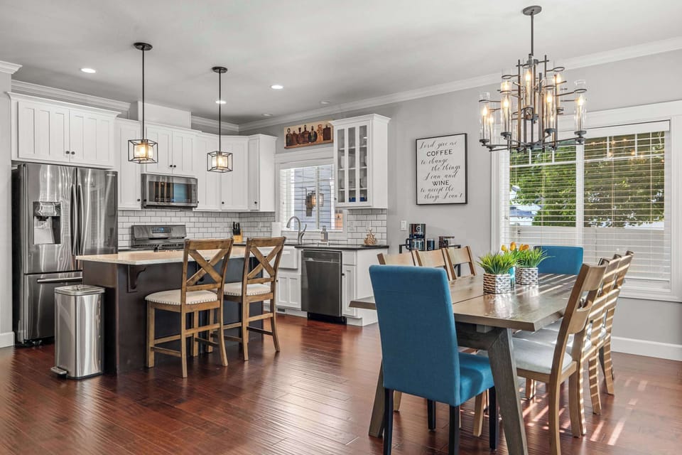 Modern kitchen with stainless appliances + quartz counters.