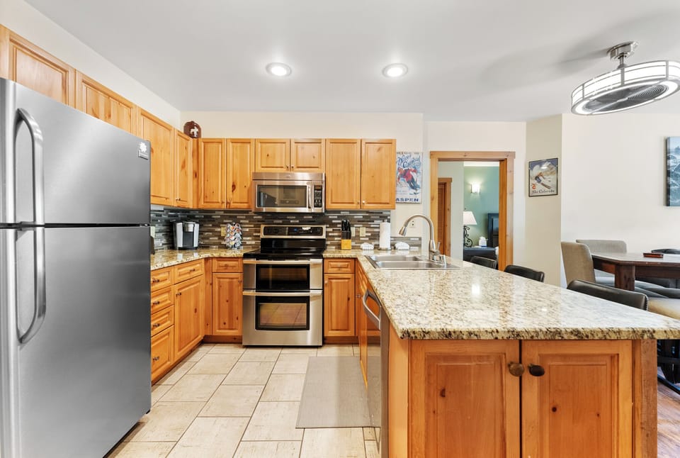Cook like a chef in your fully equipped kitchen with granite counters, stainless steel appliances, and warm wood cabinetry.