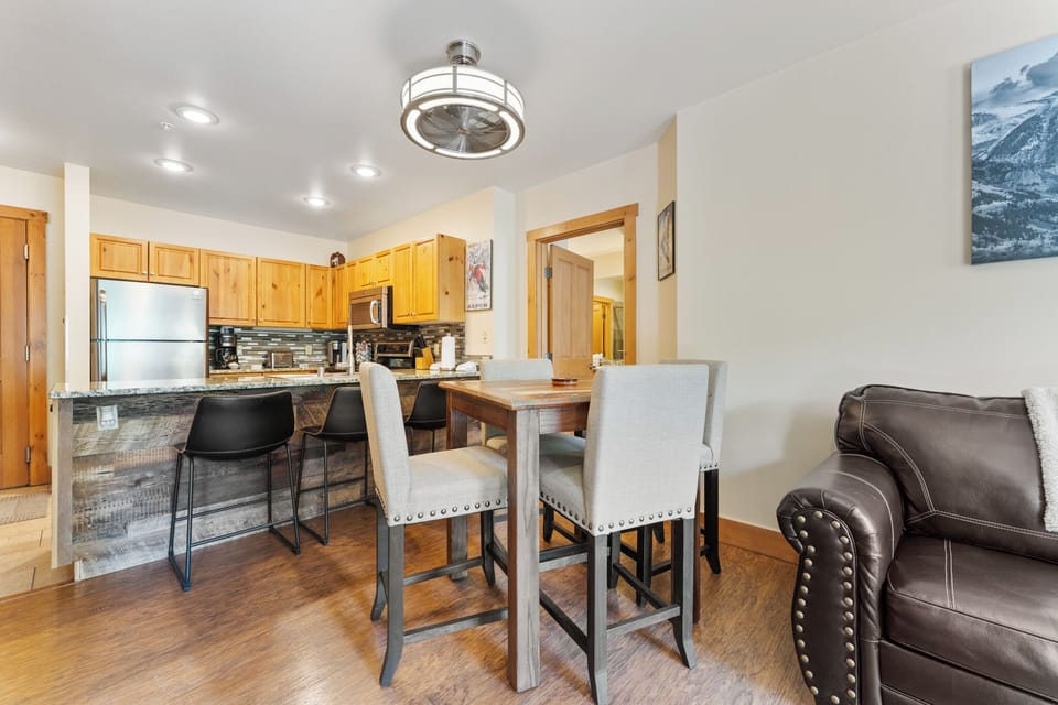 Your open-concept space seamlessly blends kitchen and living areas, with granite countertops, modern appliances, and comfortable seating for memorable meals together.
