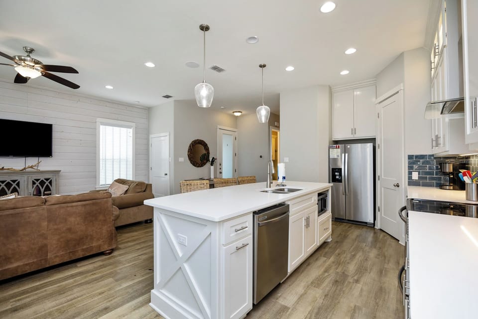 Your open-concept kitchen flows seamlessly into the cozy living room, featuring modern appliances and a spacious island for gatherings.
