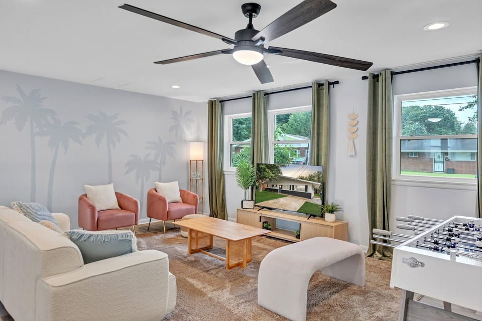 Coastal-themed living room with foosball & ceiling fan