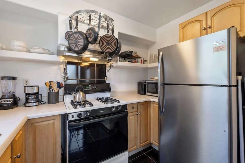 Kitchen includes a stove, fridge/freezer, and all the needed small appliances. 