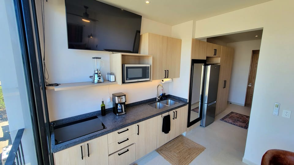 Frig, microwave, 4 burner stovetop, coffee maker, blender, Ninja oven.
