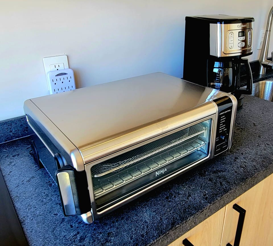 Ninja Oven/air fryer/toaster rotates down or up for space saving storage.
