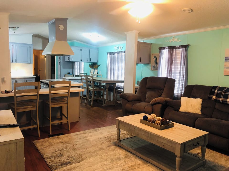Comfy living room with reclining couches and  reclining love seat.  