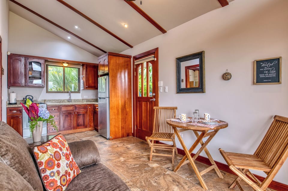 looking into the common room with full kitchen, sofa and dining area.