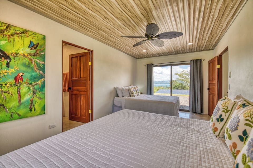 The second bedroom with ensuite bath and walk-out patio doors