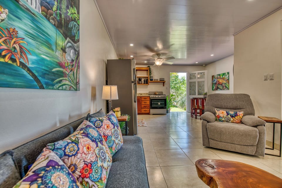 Living area looking out the door to the beautiful flora and fauna and the stairs that lead to the hot tub.