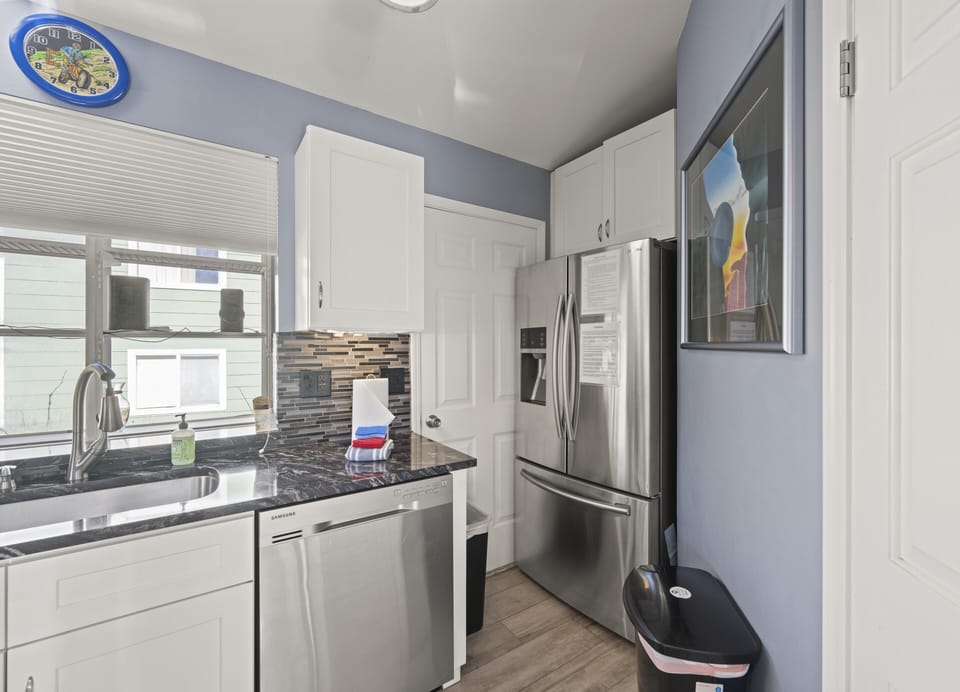 Kitchen with stainless fridge and plentiful storage for easy meal prep.