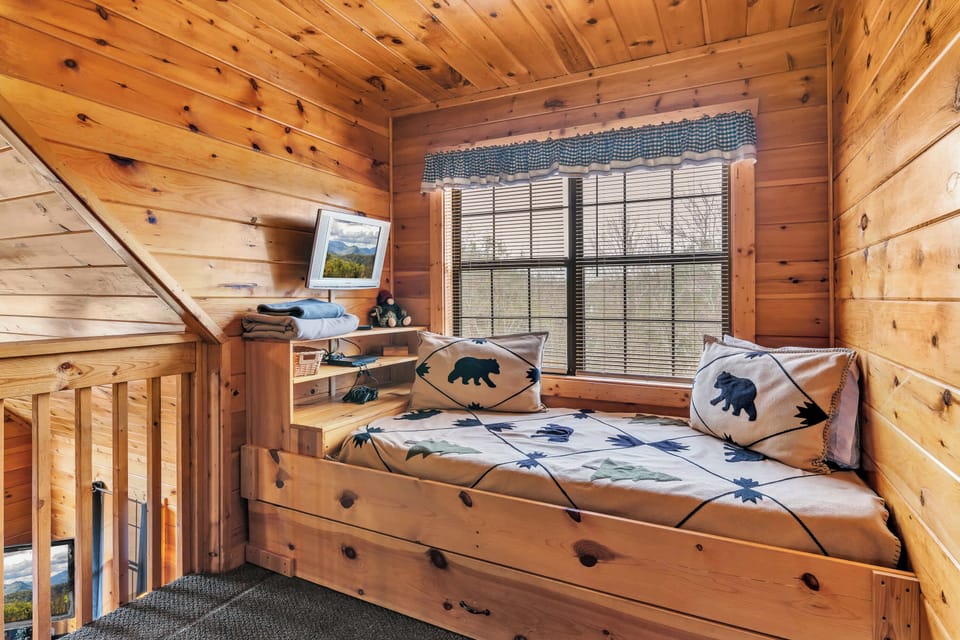 Retreat to the loft sleeping nook, showcasing a twin daybed & twin trundle