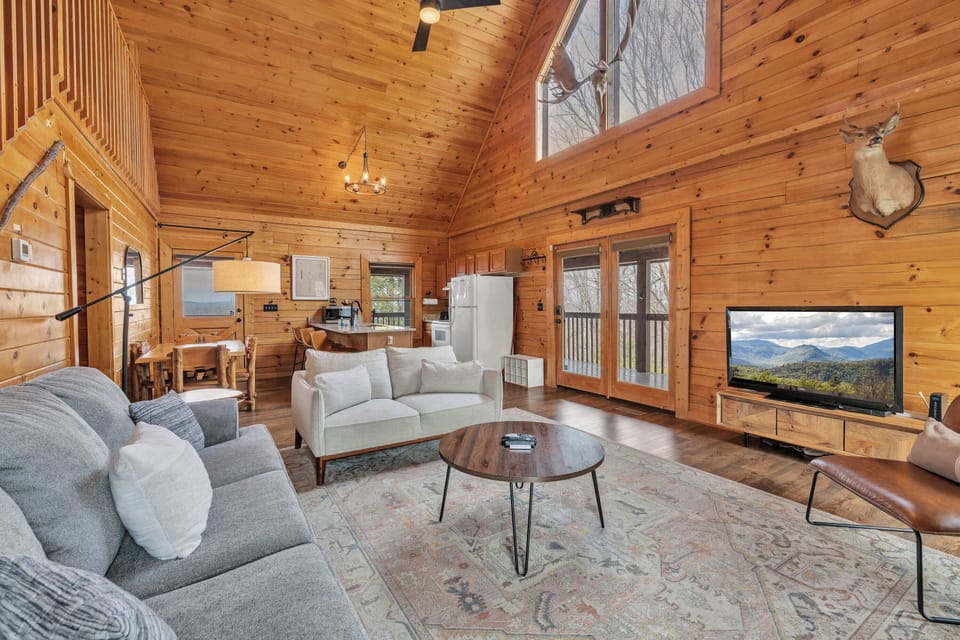 Spacious living area featuring generous seating, a Smart TV, and a cozy fireplace