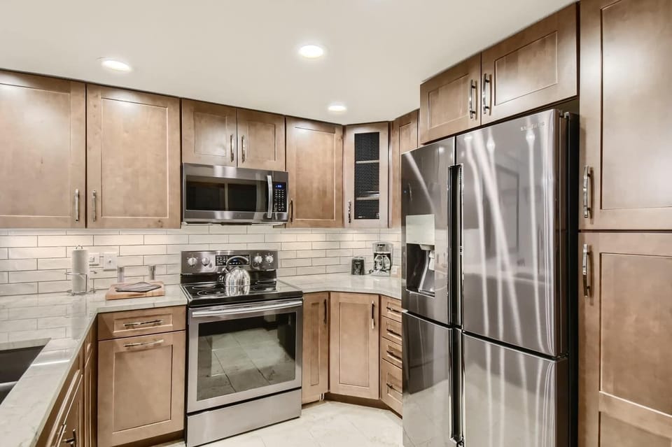 Fully equipped kitchen with electric stove, coffee maker, toaster and more