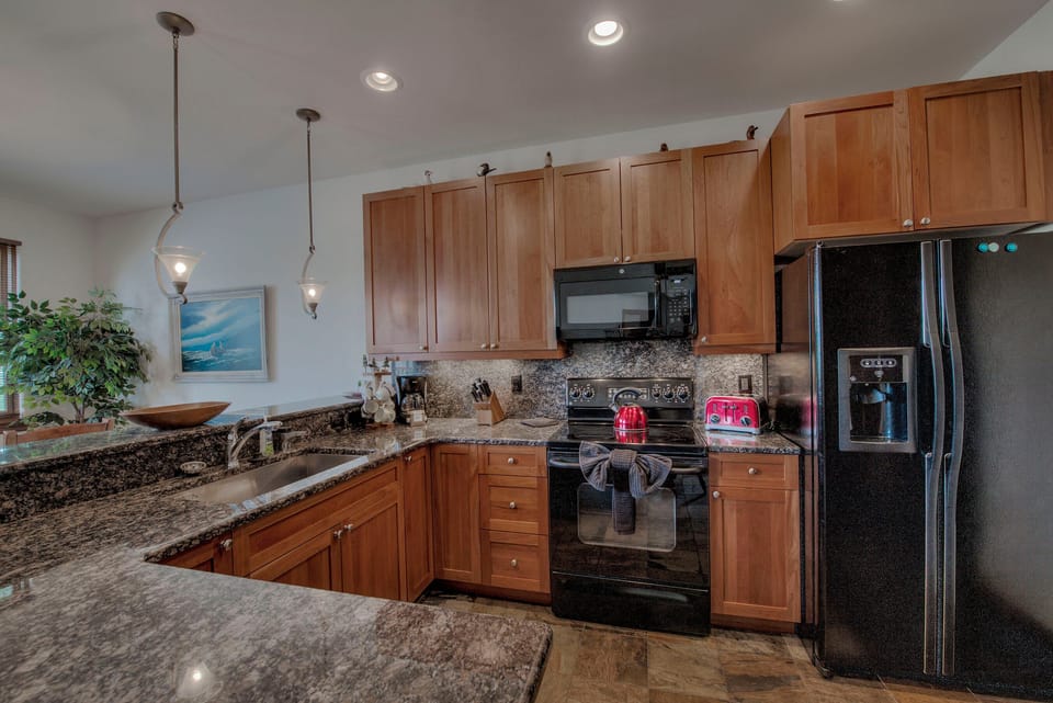 Kitchen with drip coffee maker, toaster, blender, slow cooker, and more