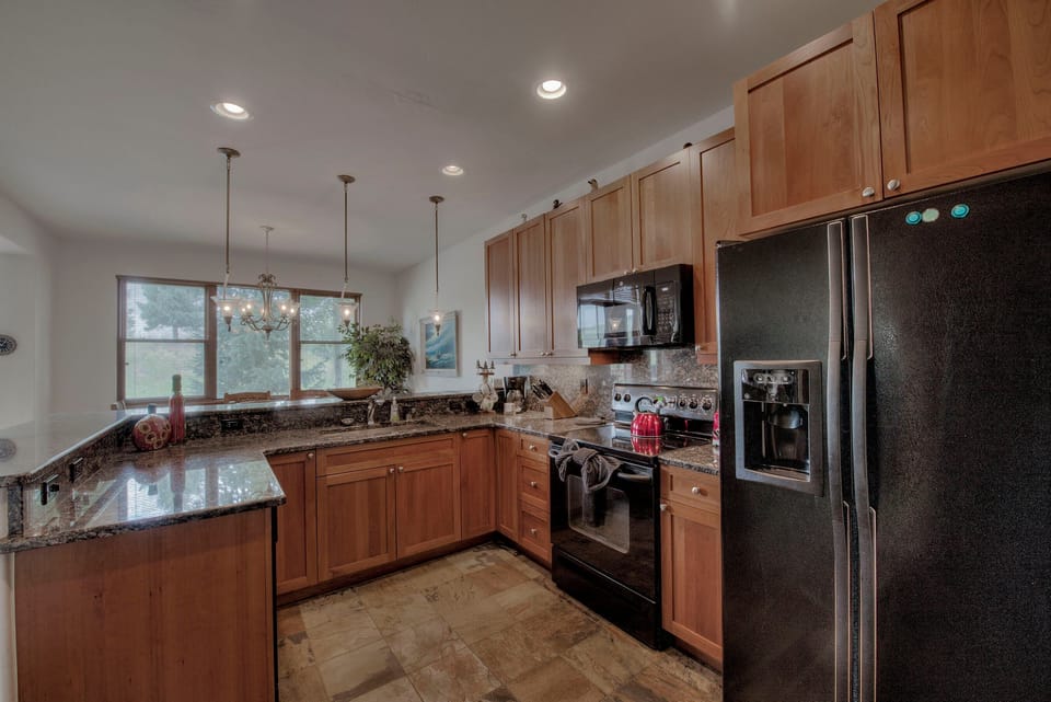Kitchen with drip coffee maker, toaster, blender, slow cooker, and more