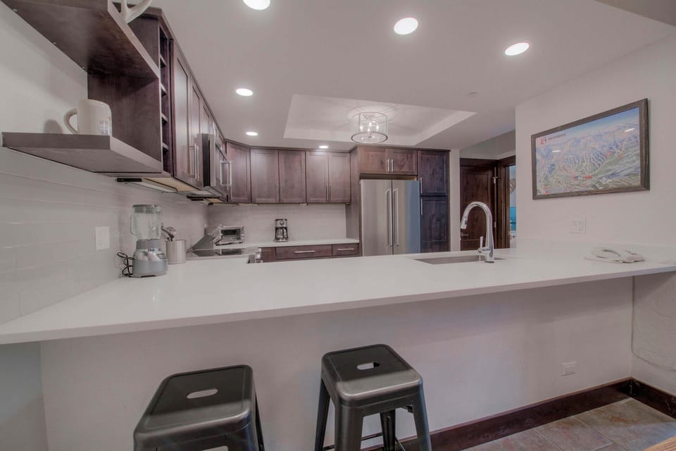 Kitchen with drip coffee maker, blender, slow cooker, toaster oven and more