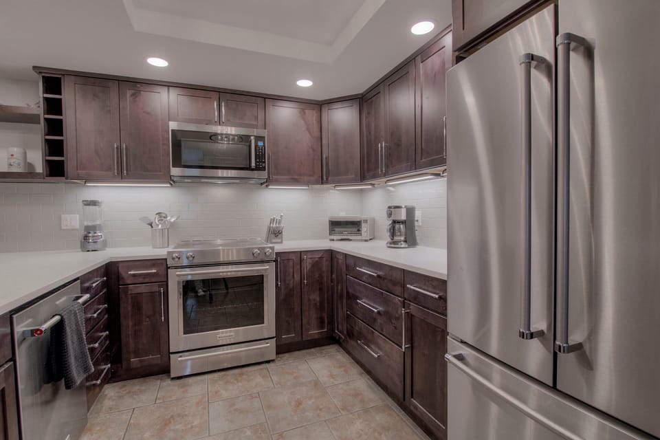 Kitchen with drip coffee maker, blender, slow cooker, toaster oven and more