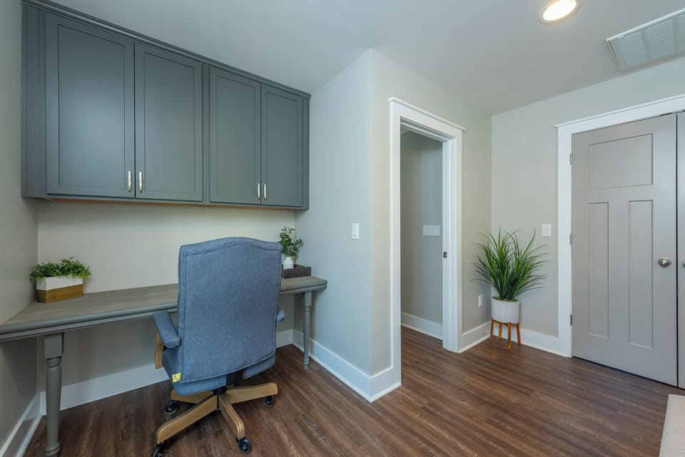 Upper-level landing with designated work space and desk chair.