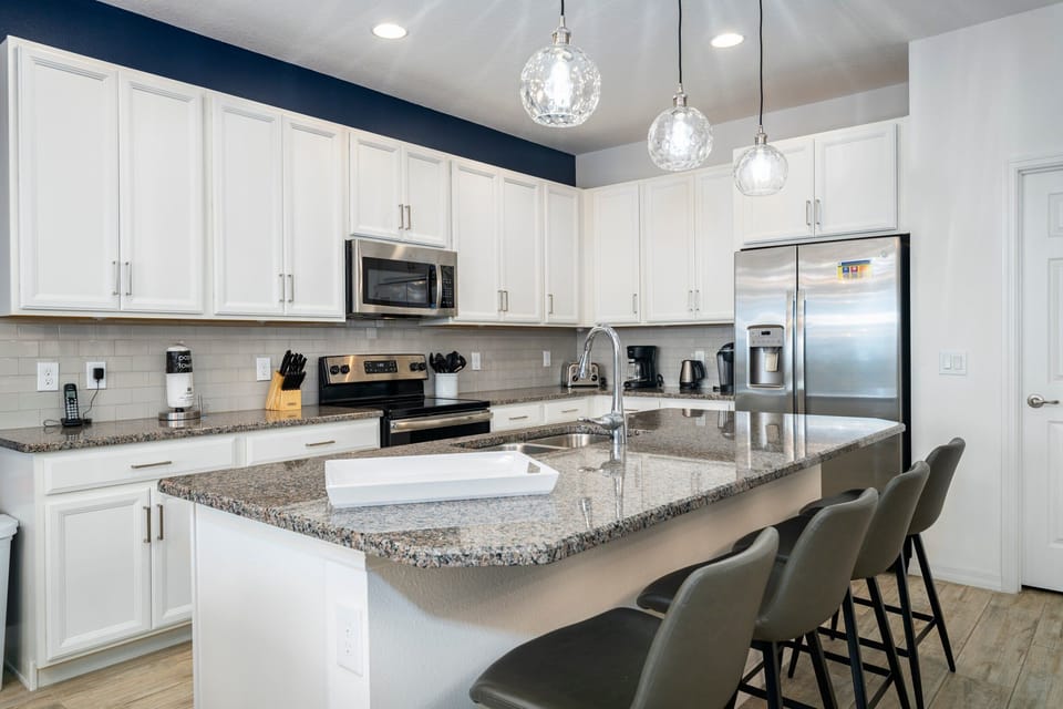 Kitchen showing modern fresh new kitchen and seating for 4 at the breakfast bar