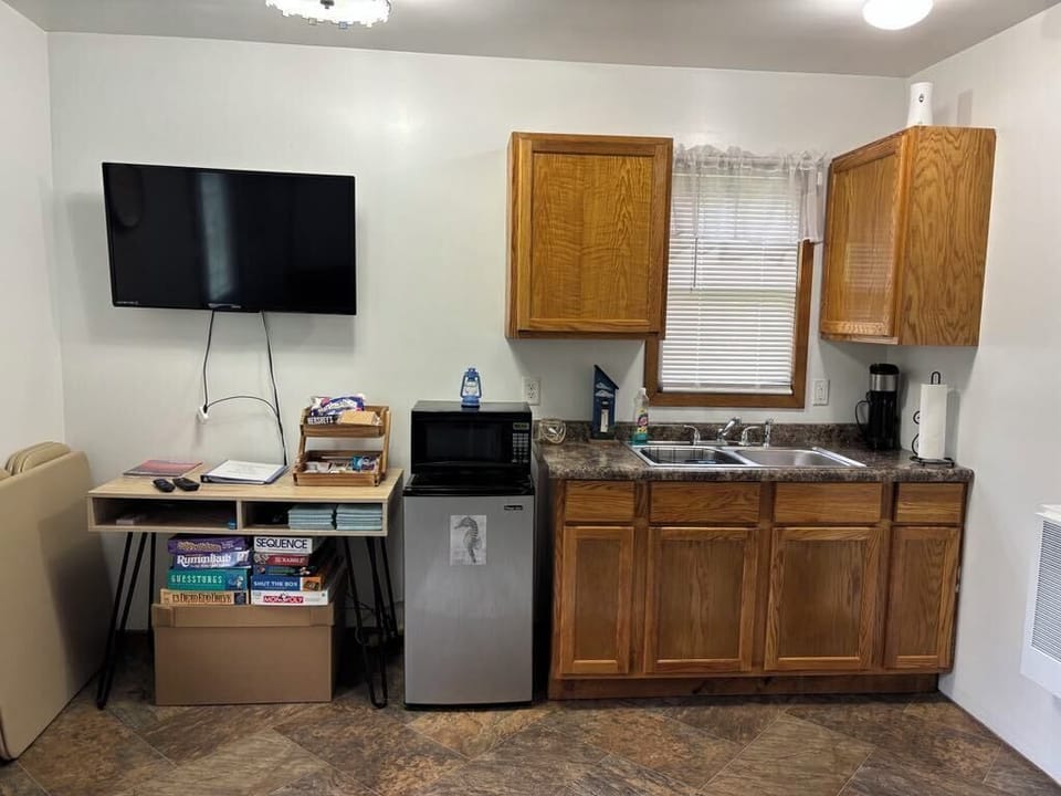 Beachy Kitchen w/ mini fridge, microwave, coffee maker, toaster, dinnerware.