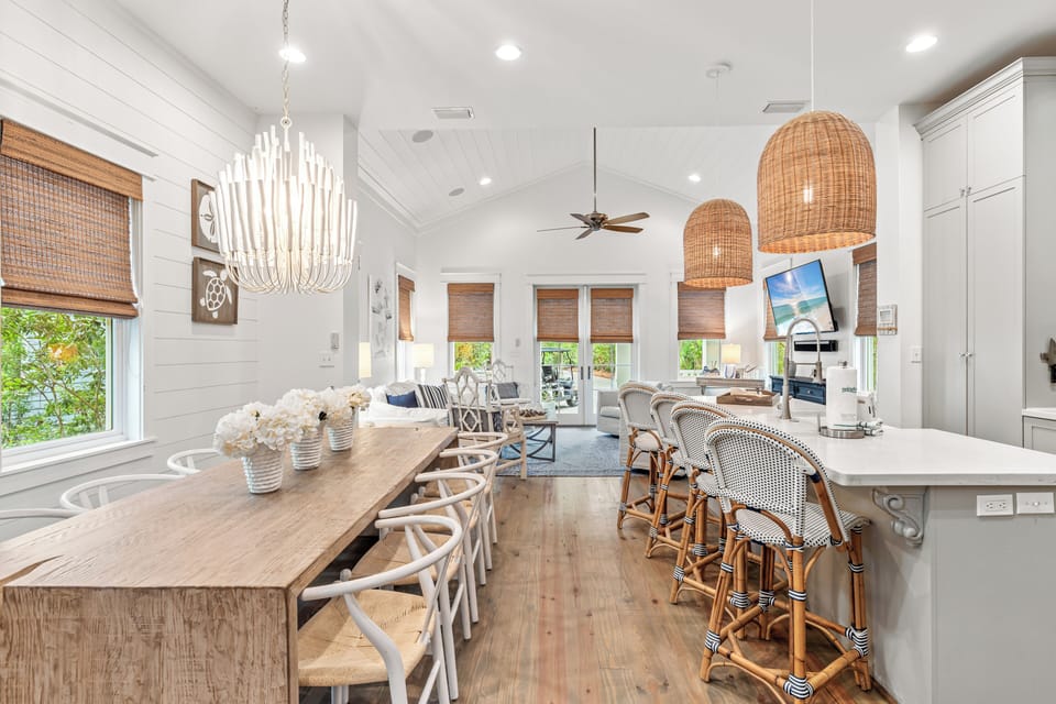 Your spacious open kitchen flows seamlessly into a welcoming dining area where memorable meals await around the natural wood table.