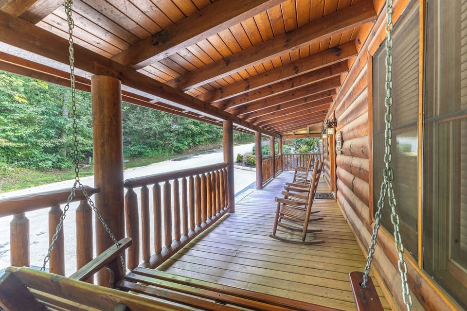 Wide open wrap around front porch with plenty of rockers and a hand carved swing