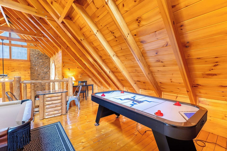 Upstairs full size bed with pool table, air hockey, multi player arcade game.