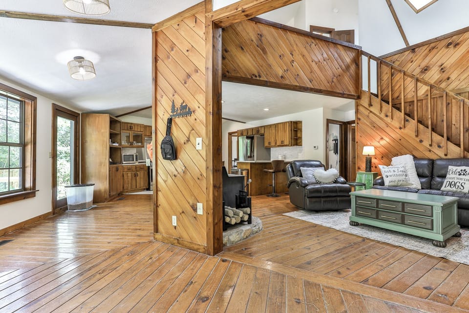 Upon entering, you see a cozy living area furnished with comfortable seating. The space is anchored by a 65-inch Roku Smart TV, complete with complimentary YouTube TV,T two single leather reclining chairs, noted for being "super comfy to take a nap".