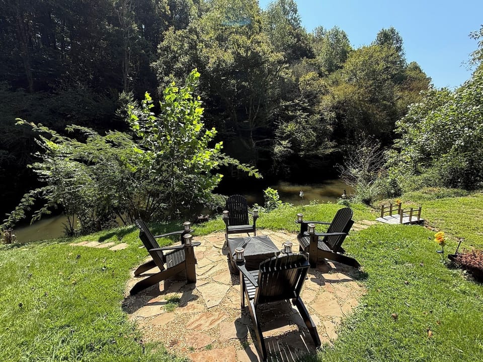 4 oversized Adirondack chairs in black, very roomy and super comfy to enjoy the fire pit at the river level.