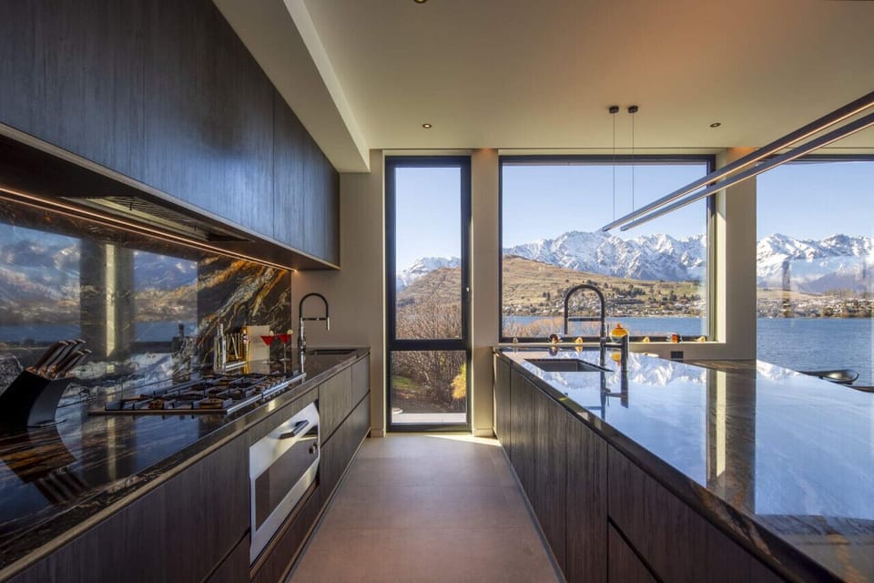 The kitchen includes a Gaggenau 5-burner gas cooktop, an oversized Gaggenau oven, a French door fridge freezer, Nespresso coffee machine and more