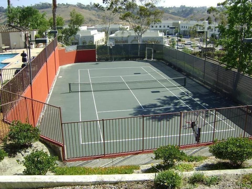 Tennis court right below the large swimming pool.