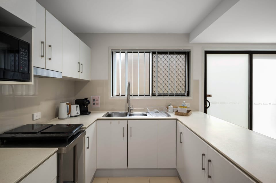 Kitchen: Sleek kitchen with ample storage, modern appliances 