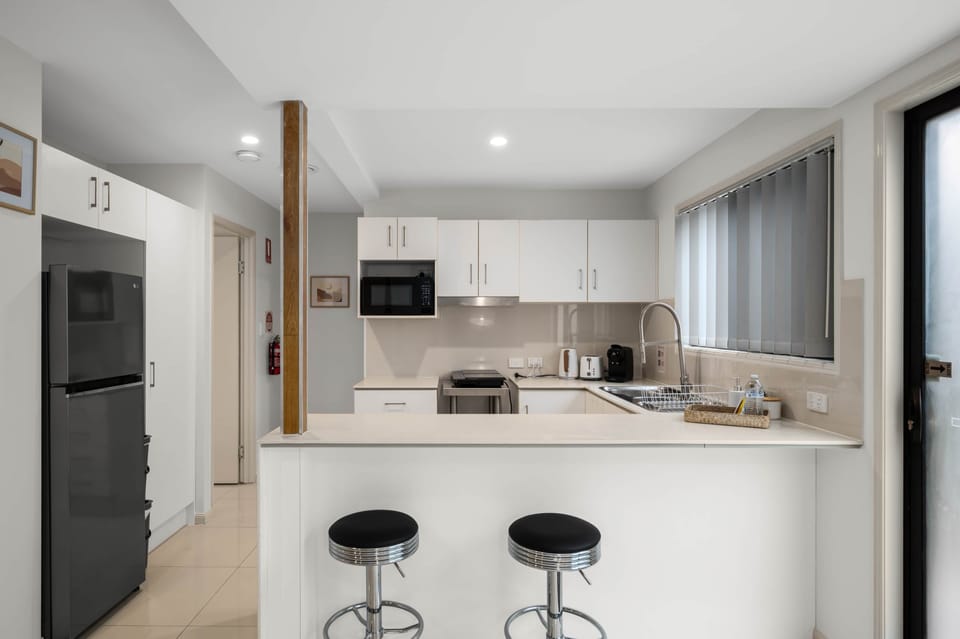 Kitchen: Sleek kitchen with ample storage, modern appliances 
