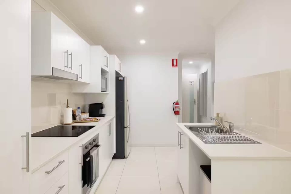 Kitchen: Sleek kitchen with ample storage, modern appliances 