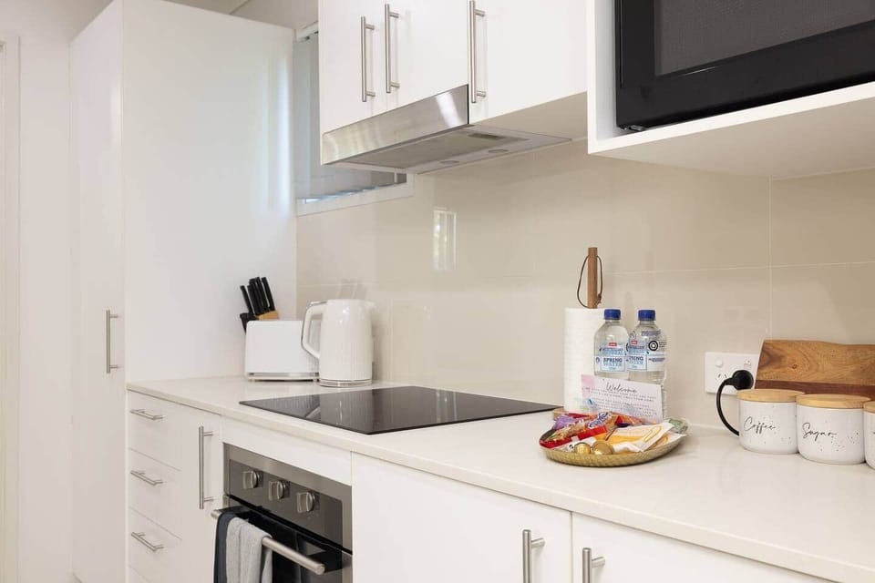 Kitchen: Sleek kitchen with ample storage, modern appliances 