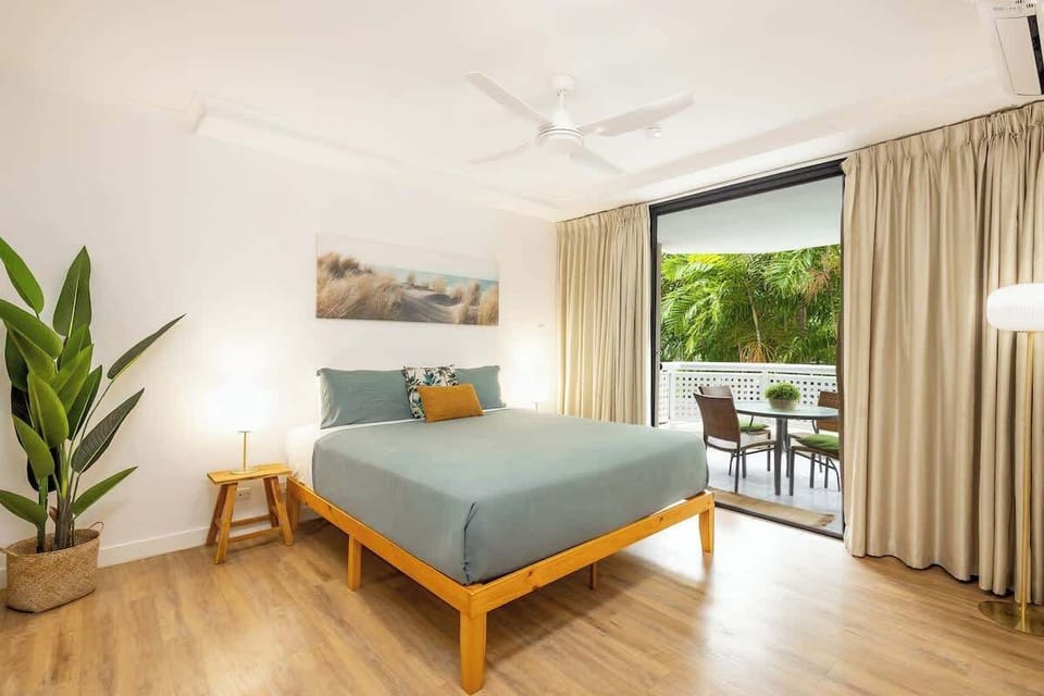 Wake refreshed in the bedroom, where a king bed, calming interiors, and direct balcony access create a peaceful retreat surrounded by tropical greenery.