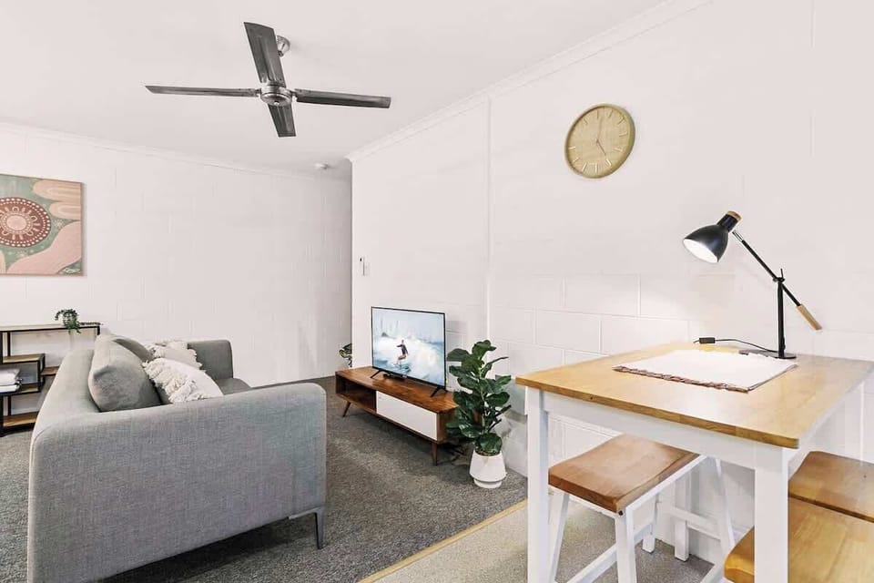 Enjoy slow mornings at the dining area, where a timber table creates a cosy spot for coffee, casual meals, or planning the day’s adventures around Cairns.