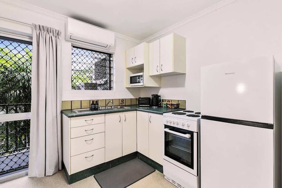 The compact kitchen is thoughtfully equipped for easy stays, with an oven, electric stove, microwave, and full-sized fridge ready for everything from quick breakfasts to relaxed dinners at home.