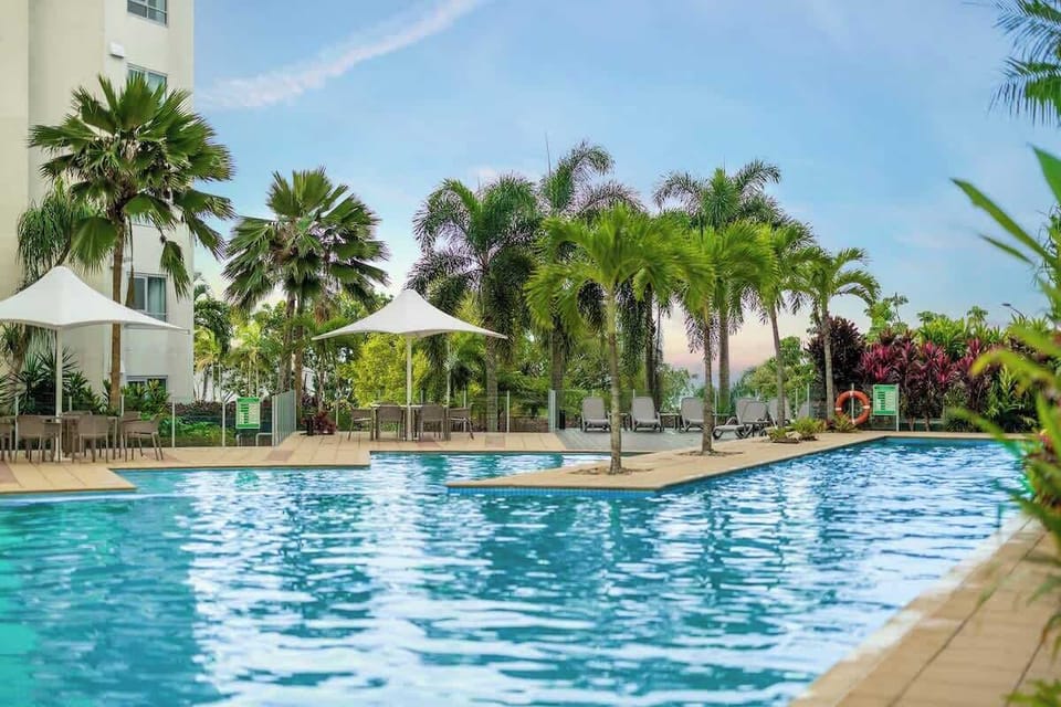 Spend sunny afternoons beside the shared lagoon-style pool, surrounded by tropical palms and lounging areas that bring a relaxed resort atmosphere to your stay.