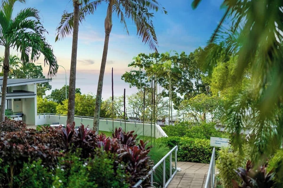 Wander through the lush shared gardens where tropical greenery, ocean glimpses and swaying palms create a peaceful escape just moments from the city buzz.