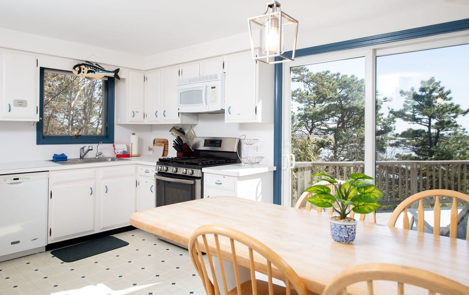 Fully equipped kitchen and cozy dining area, perfect for enjoying family meals with a view.
