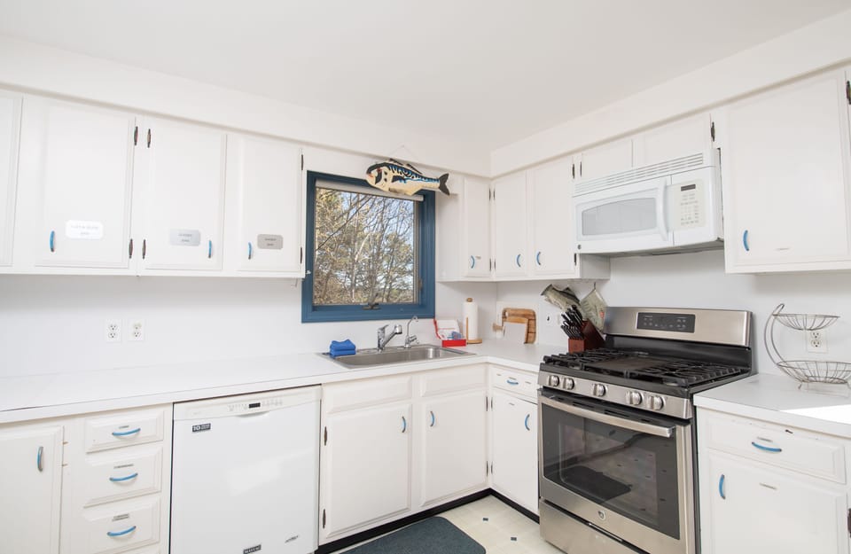 Bright and functional kitchen with ample counter space, large windows, and all the essentials for your stay.