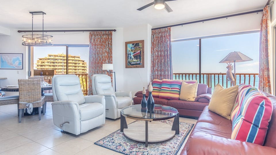 The living room combines comfortable leather sofas, and two leather recliners also.