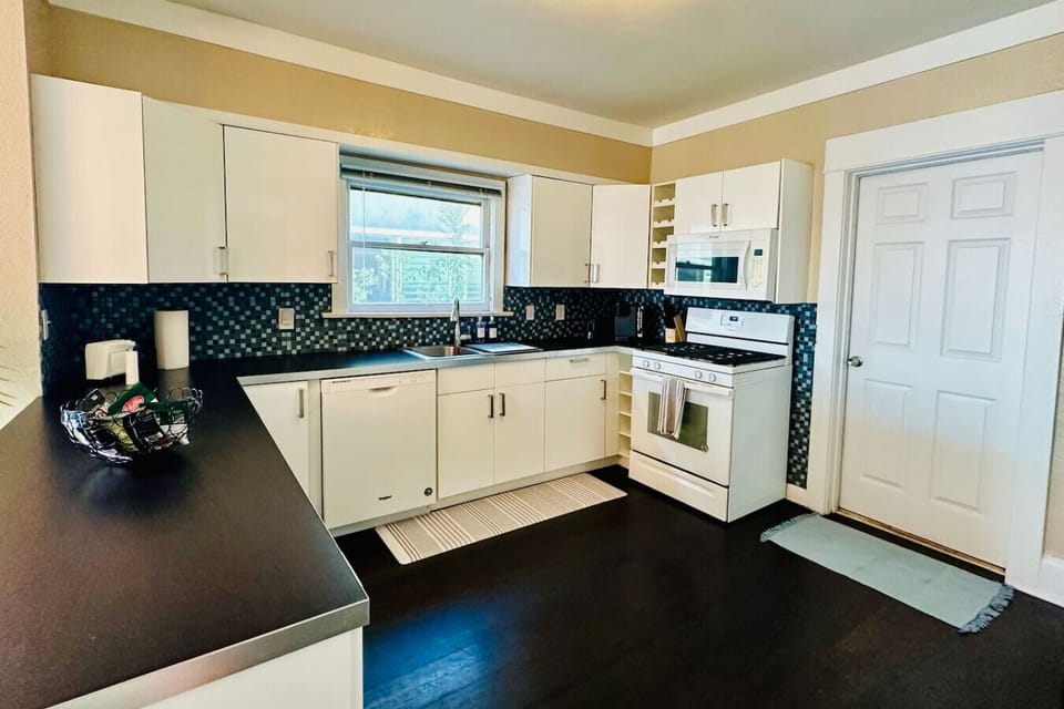 Large kitchen, fully equipped, gas stove, microwave, dishwasher, and all cooking essentials.