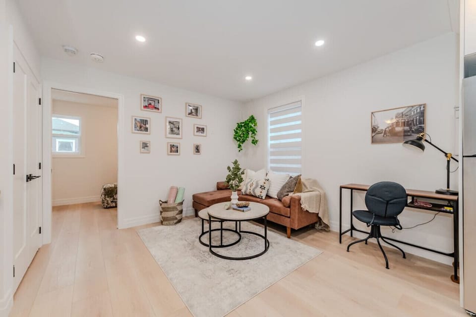 Stylish living room featuring a smart TV, tasteful decor, and a dedicated workspace—ideal for both relaxation and productivity in a beautifully designed setting.