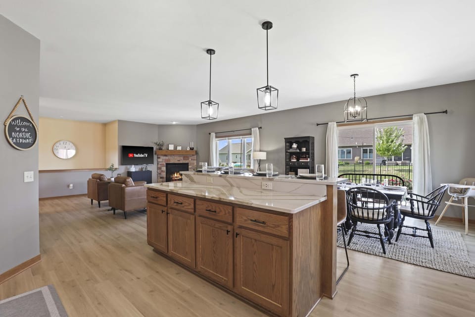 Fully stocked kitchen with barstool seating and a dining table that comfortably seats 6.